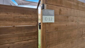 A wooden fence with a sign indicating "Crown Point Tiny Homes" and a room number "C-12". - Lake Simtustus Resort Crown Point Tiny Home #11 - Hot Tub (Madras)