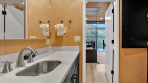 A modern bathroom with a large sink, two towel dispensers, and a mirror. - Lake Simtustus Resort Crown Point Tiny Home #11 - Hot Tub (Madras)