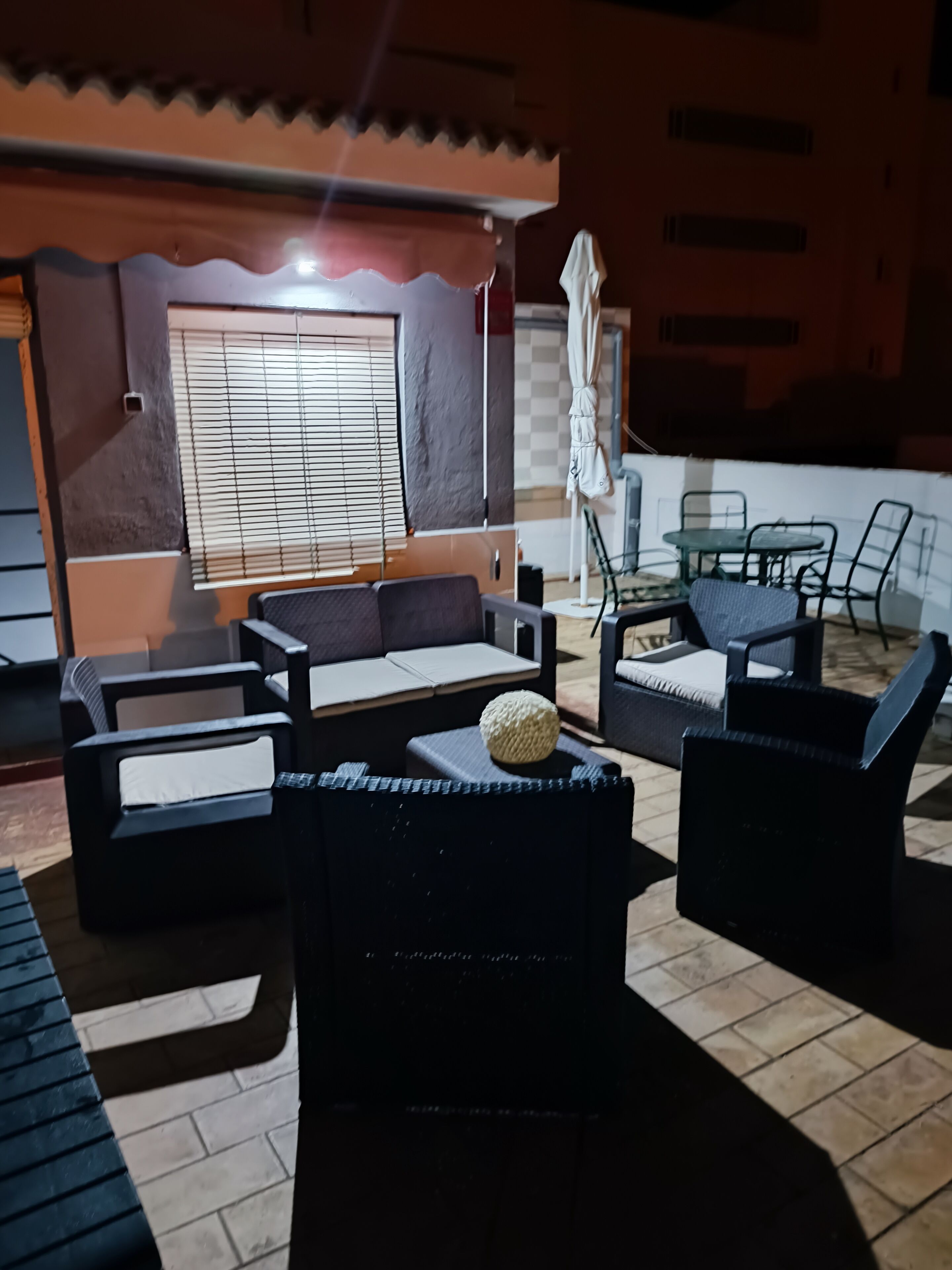 A patio area with outdoor furniture, including sofas and chairs, and a table.