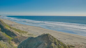 A beach with a clear sky and gentle waves. - Seascape Aptos Retreat w/ Bocce Ball Court! (Aptos)