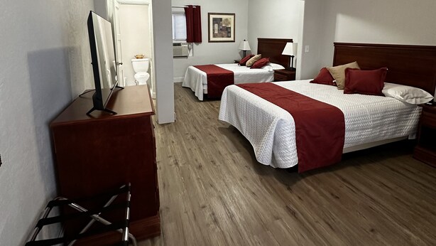 A hotel room with two beds, a desk, a chair, and a television. - Arizona 9 Motor Hotel  (Williams)