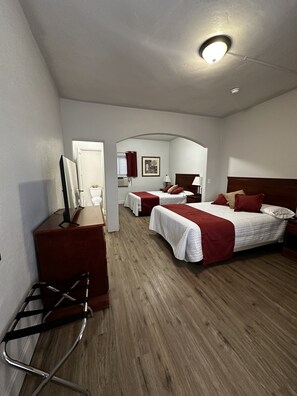 A hotel room with two beds, a desk, a chair, and a television. - Arizona 9 Motor Hotel (Williams)