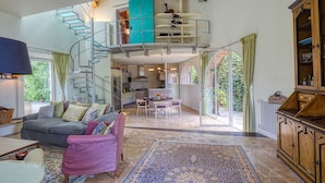 A spacious living area with a staircase leading to a mezzanine, a dining area, and a kitchen. - Stunning private villa with A/C, private pool, WIFI, TV, terrace, panoramic view, close to Viareggio (Camaiore)