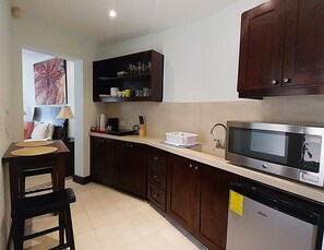 Fridge, microwave, coffee/tea maker, cookware/dishes/utensils