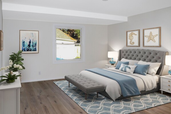 A bedroom with a tufted headboard bed, a bench at the foot of the bed, a window with a view of the outdoors, and two framed seahorse pictures on the wall.