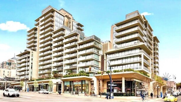A modern multi-story hotel with a prominent corner entrance, balconies, and a ground-level commercial area. - Waterfalls Hotel in Downtown With Stunning Views! (Victoria)