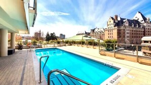 A swimming pool with a view of historic buildings. - Waterfalls Hotel in Downtown With Stunning Views! (Victoria)