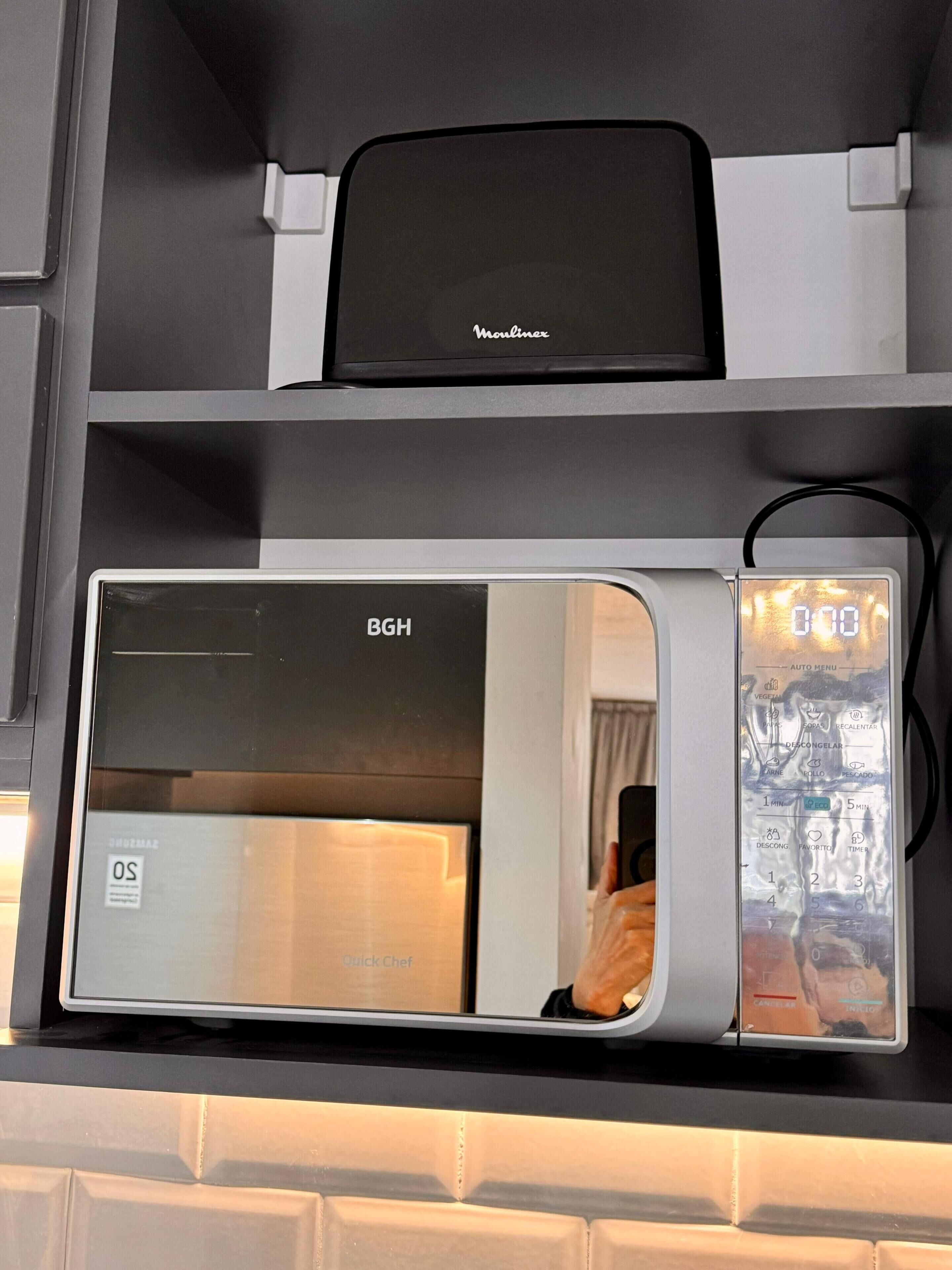 A modern microwave oven with a digital display and a control panel.