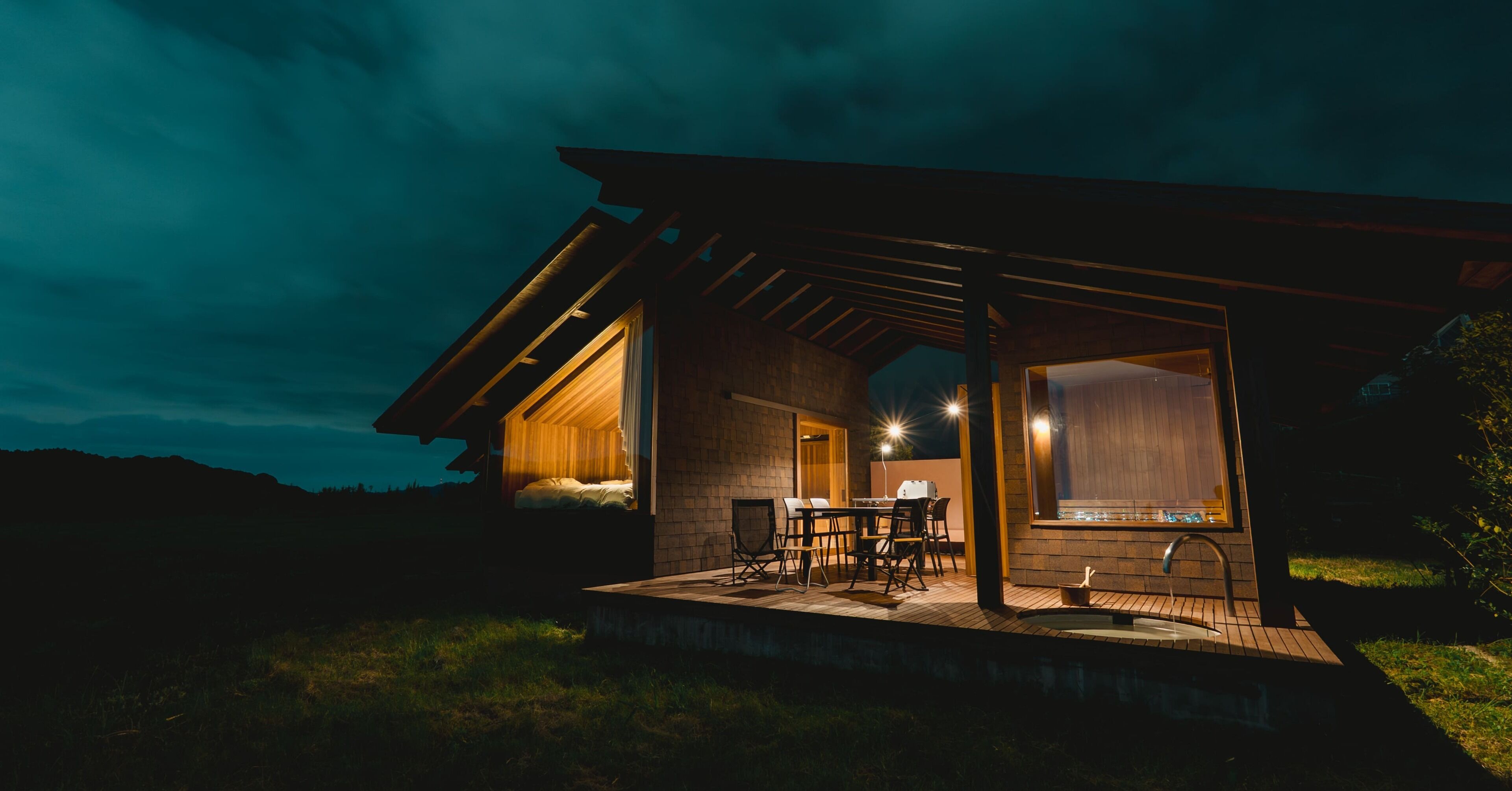 A modern house with a covered patio, a dining area, and a visible kitchen.
