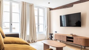 A living room with a sofa, a coffee table, a TV, and a wooden cabinet. - 1 Bedroom#4 pers#Mouffetard#Port-Royal#La Sorbonne (Paris)