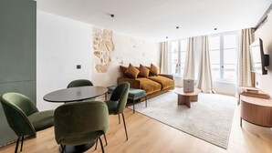 A modern living room with a sofa, two armchairs, a round table, and a coffee table. - 1 Bedroom#4 pers#Mouffetard#Port-Royal#La Sorbonne (Paris)