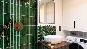 A bathroom with a green-tiled wall, a round sink, a mirror, and a washing machine. - 1 Bedroom#4 pers#Mouffetard#Port-Royal#La Sorbonne (Paris)