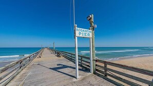 A wooden pier extending into the ocean with a sign reading "Rodanthe Pier". - Renovated - Seaside 5BR Caribbean Escape near the Rodanthe Pier (Rodanthe)