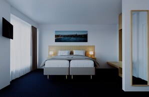 A hotel room with a bed, a flat-screen TV, a painting, and a mirror.