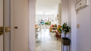 A hallway leading to a dining area with a view of the outdoors.