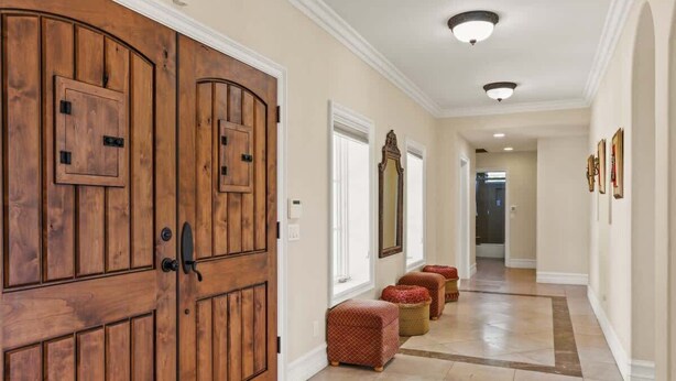 A hallway with wooden doors, a mirror, and a tiled floor. - City View Rancho Palos Verdes Home (Rancho Palos Verdes)