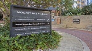 A sign for MOUNT'S BAY VILLAGE with directions to various amenities including a restaurant, reception, service deliveries, and carparks. - Panoramic Perth Views: 1BR on Mounts Bay Road (Perth)