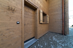 A wooden exterior wall with a nameplate reading 'BRIST' and a window with wooden shutters.