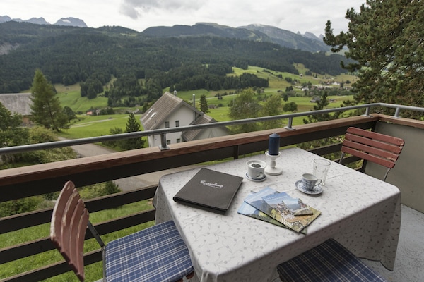 Balcony dining area with views of the Churfirsten