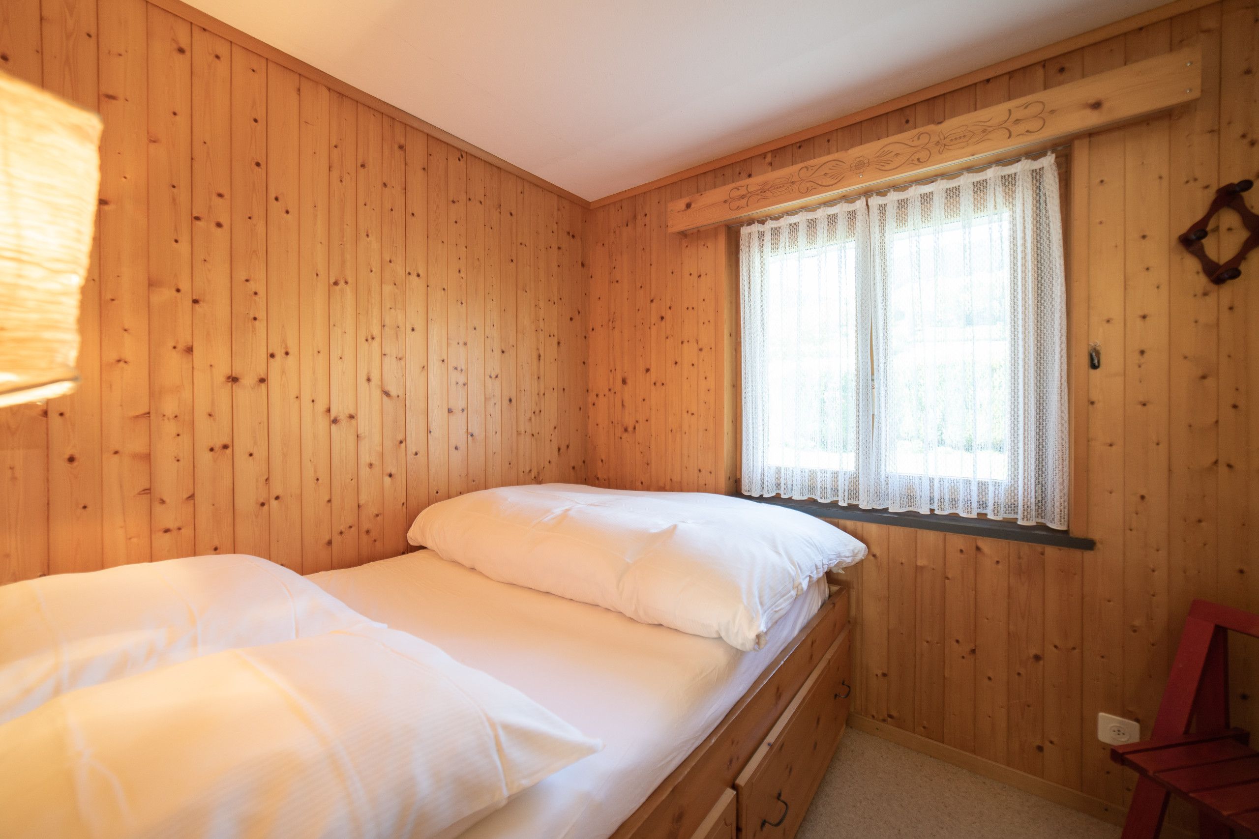 Bedroom with two single beds and wooden interior