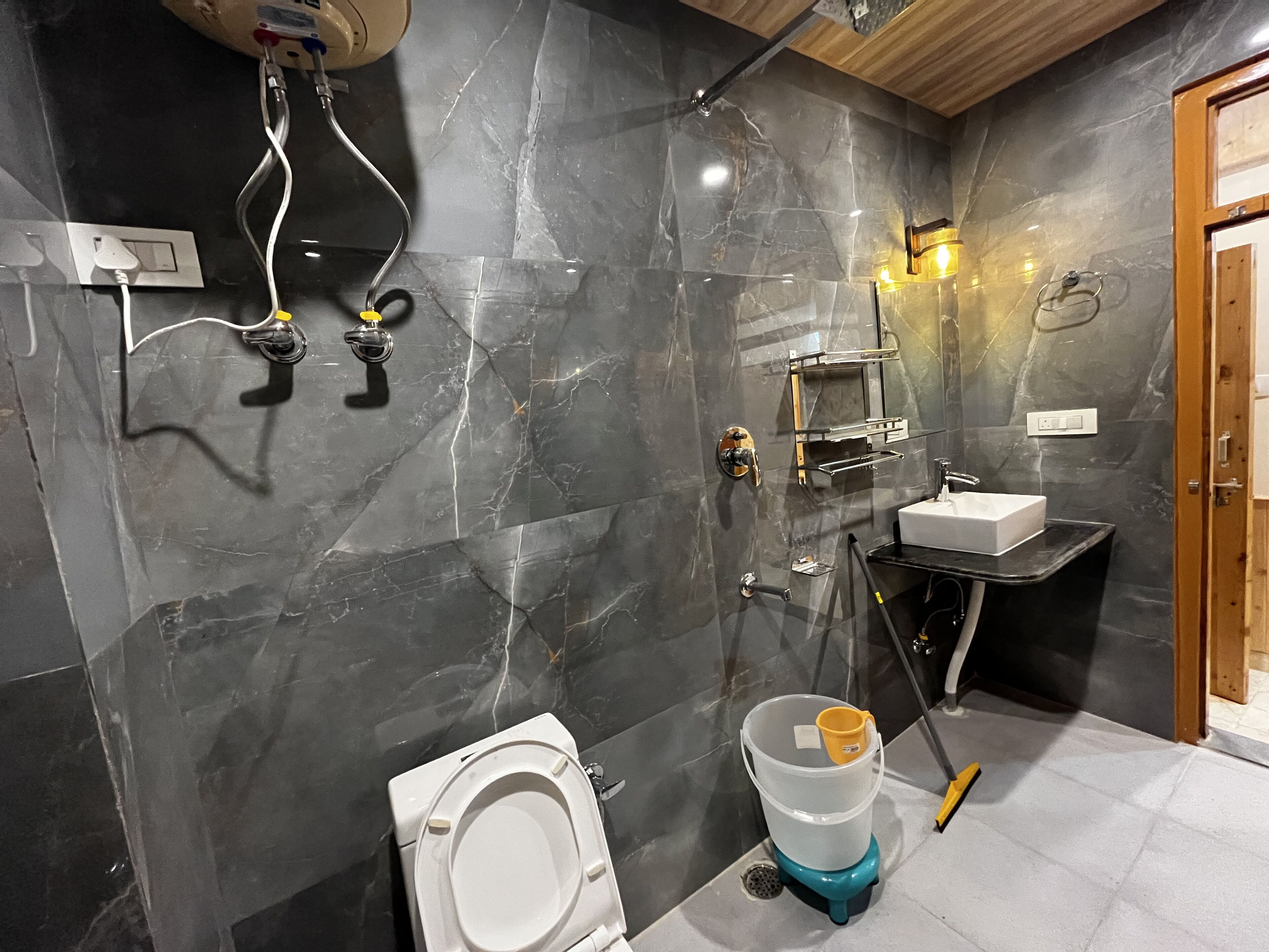 A modern bathroom with a toilet, sink, and shower.