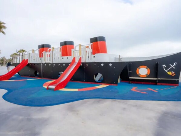 A children's play area with slides and a lifebuoy symbol.