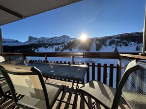 A deck with a table and chairs overlooking a snowy mountain landscape. - Studio for 4, near chairlift, WiFi, parking - SuperDévoluy (Le Dévoluy)
