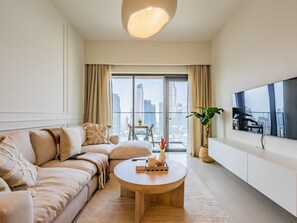 Deluxe Apartment | Living area | 55-inch Smart TV with cable channels - Exquisite 2BR - Breathtaking BurjSkyline (Dubai)