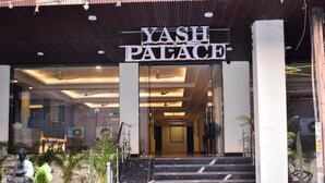 The entrance to Yash Palace with a sign, steps, and potted plants. - HOTEL YASH PALACE (New Delhi)