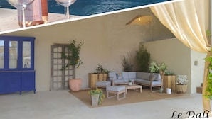 A pool area with lounge chairs and a bottle of wine. - Holiday Home Le Dali in Piolenc, in Complete Tranquility (Piolenc)