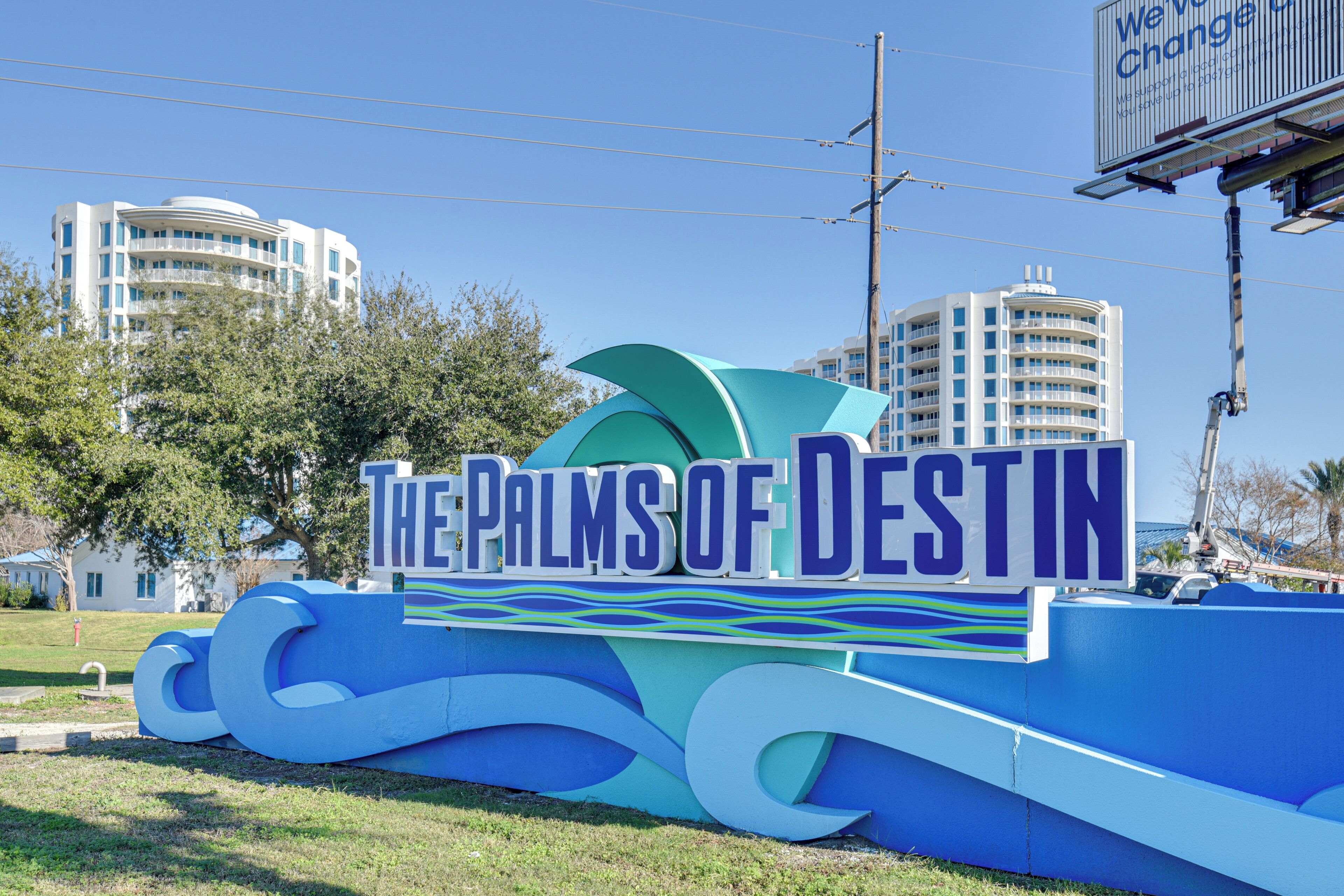 A large sign with the text 'The Palms of Destin' indicating a location.