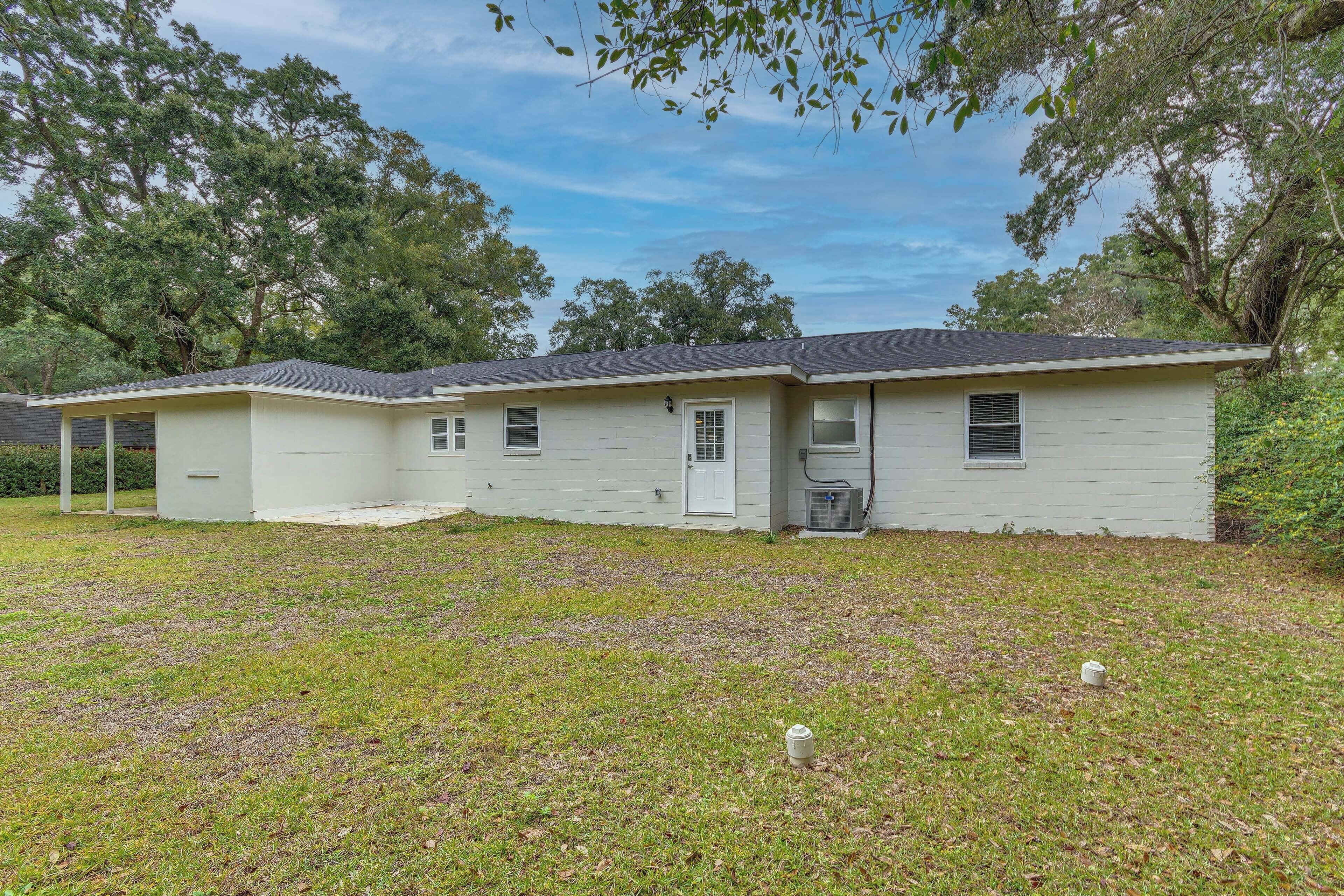 A single-story house with a covered porch, a front door, and a small attached garage.