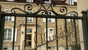 A stone building with a metal gate.