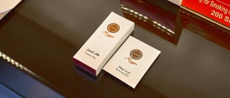 Two boxes labeled "Vanity Kit" and "Sewing Kit" on a reflective surface.