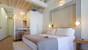 A modern bedroom with a large bed, bedside tables, a desk, and a wardrobe. - Genteel Home San Francisco III (Seville)