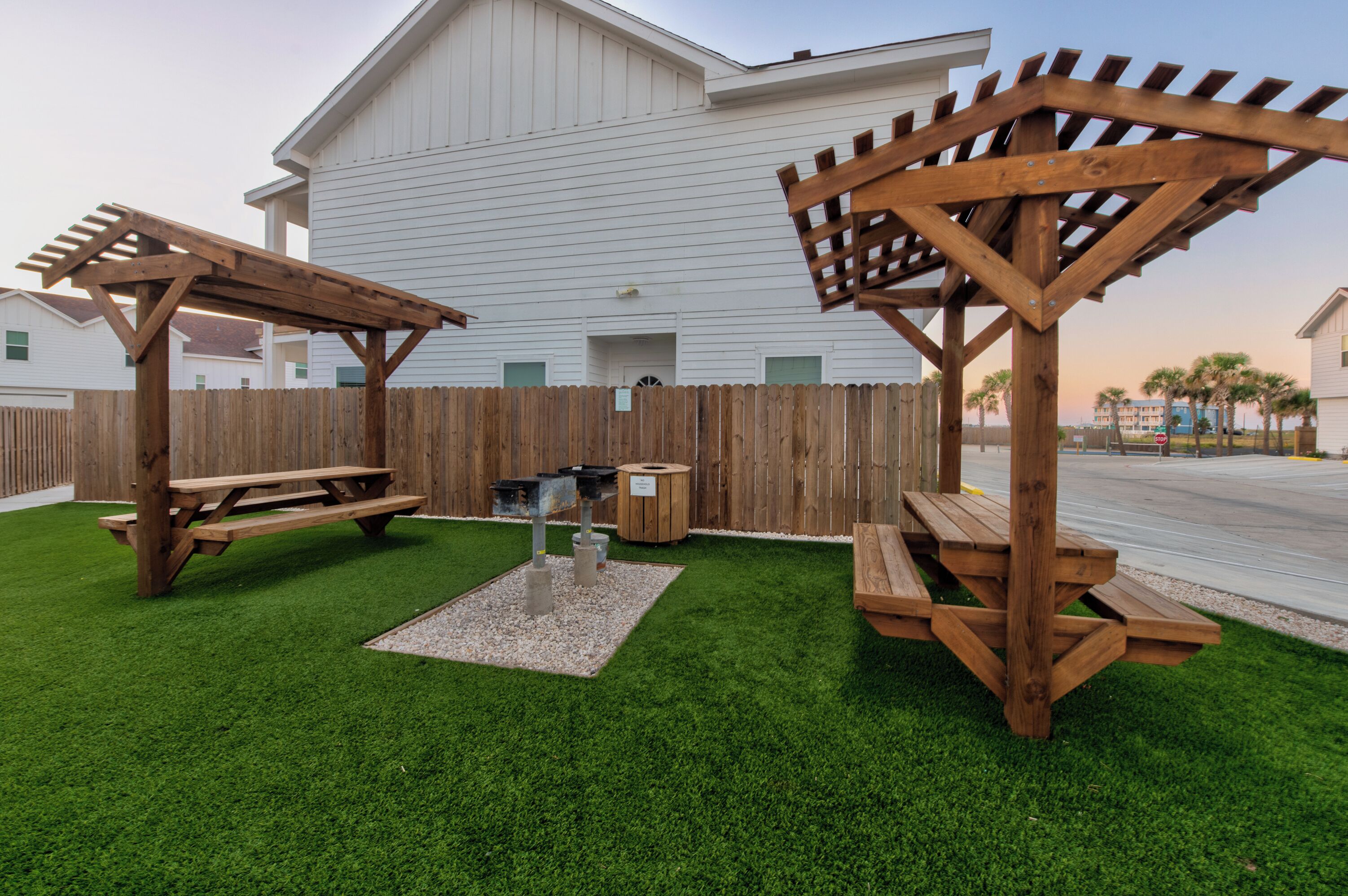 Relax under the wooden pergolas with picnic tables and BBQ grill - perfect for outdoor dining and enjoying coastal evenings together.