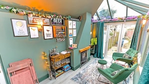 A cozy bar area with a sign reading "BEER BAR," a fireplace, and a television.