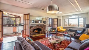 A spacious living room with a fireplace, modern furniture, and large windows. - Extraordinary Capitol Hill Home! (Salt Lake City)