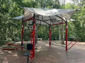 Work out in style with a variety of exercise equipment, including a pull-up bar, bench, and weight bench.