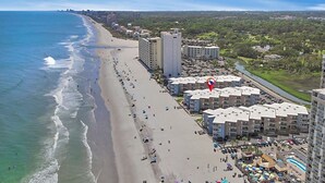 A beachfront hotel with multiple buildings, a sandy beach, and a river nearby. - Oceanview at A Place at the Beach 3 - Unit 3E (Myrtle Beach)