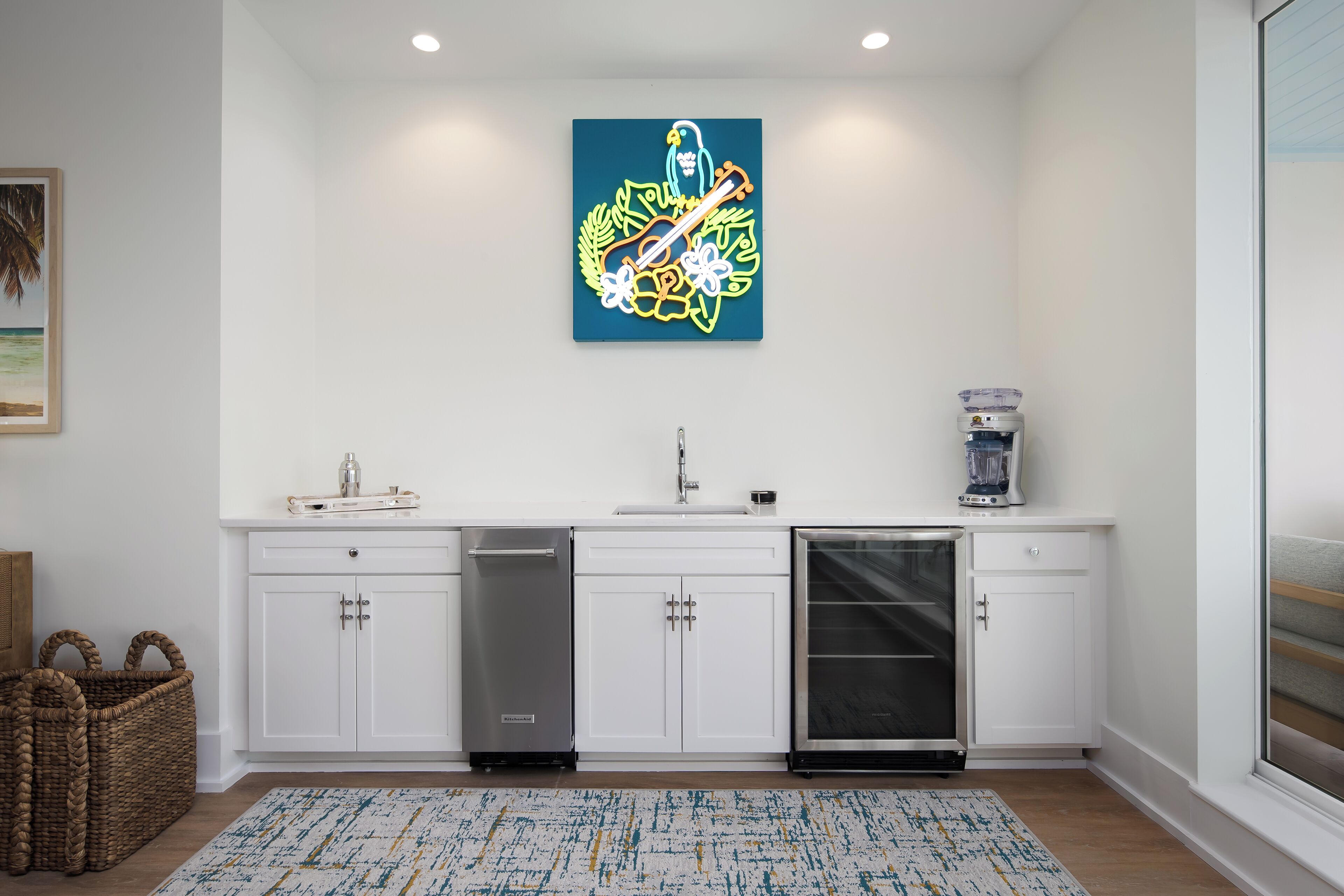 A modern kitchen with white cabinets, a dishwasher, and a coffee maker.