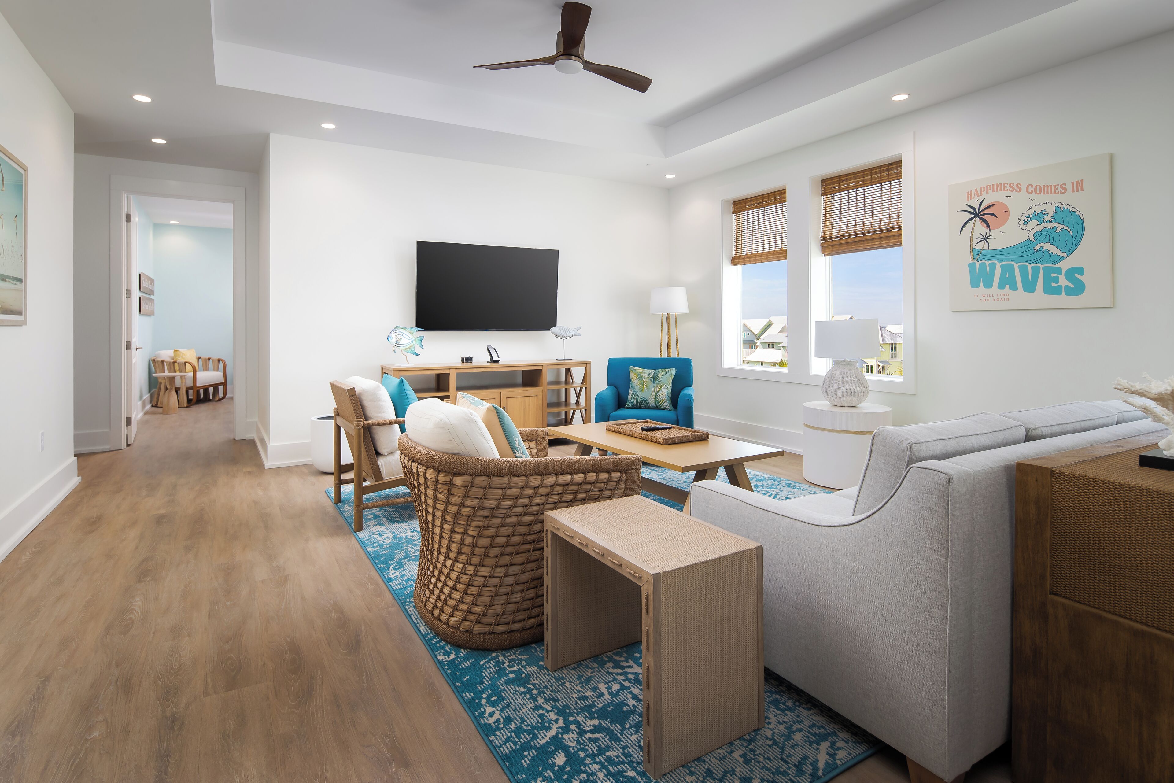 A modern living room with a sofa, a coffee table, a TV, and a dining area with chairs and a table.