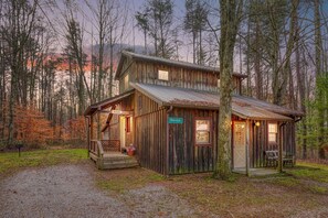 A rustic cabin with a porch, a small attached shed, and a sign reading "Navajo." - Navajo in Hocking Hills (Logan)