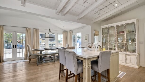 A spacious kitchen with a central island, wooden cabinets, and a large window. - Walk To Beach & Village | 5 Bedrooms | 3 Units (Carlsbad)