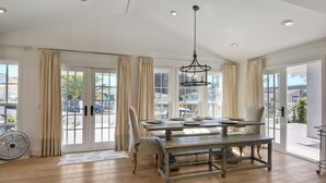 A spacious dining area with a large table, chairs, and a chandelier. - Walk To Beach & Village | 5 Bedrooms | 3 Units (Carlsbad)