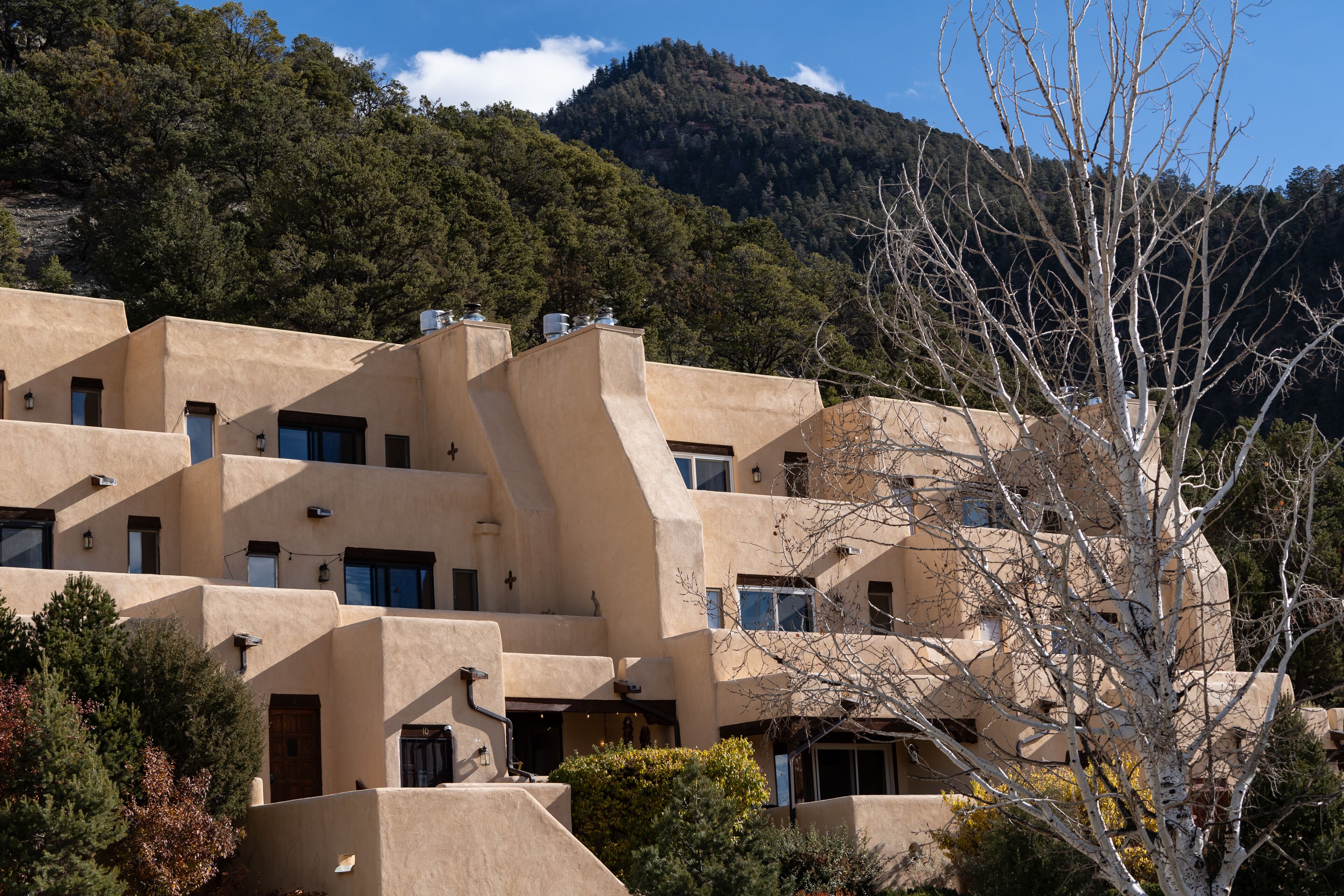 A multi-story building with a unique architectural design, featuring multiple balconies and windows.