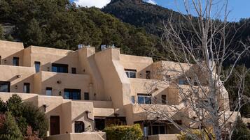 A multi-story building with a unique architectural design, featuring multiple balconies and windows.