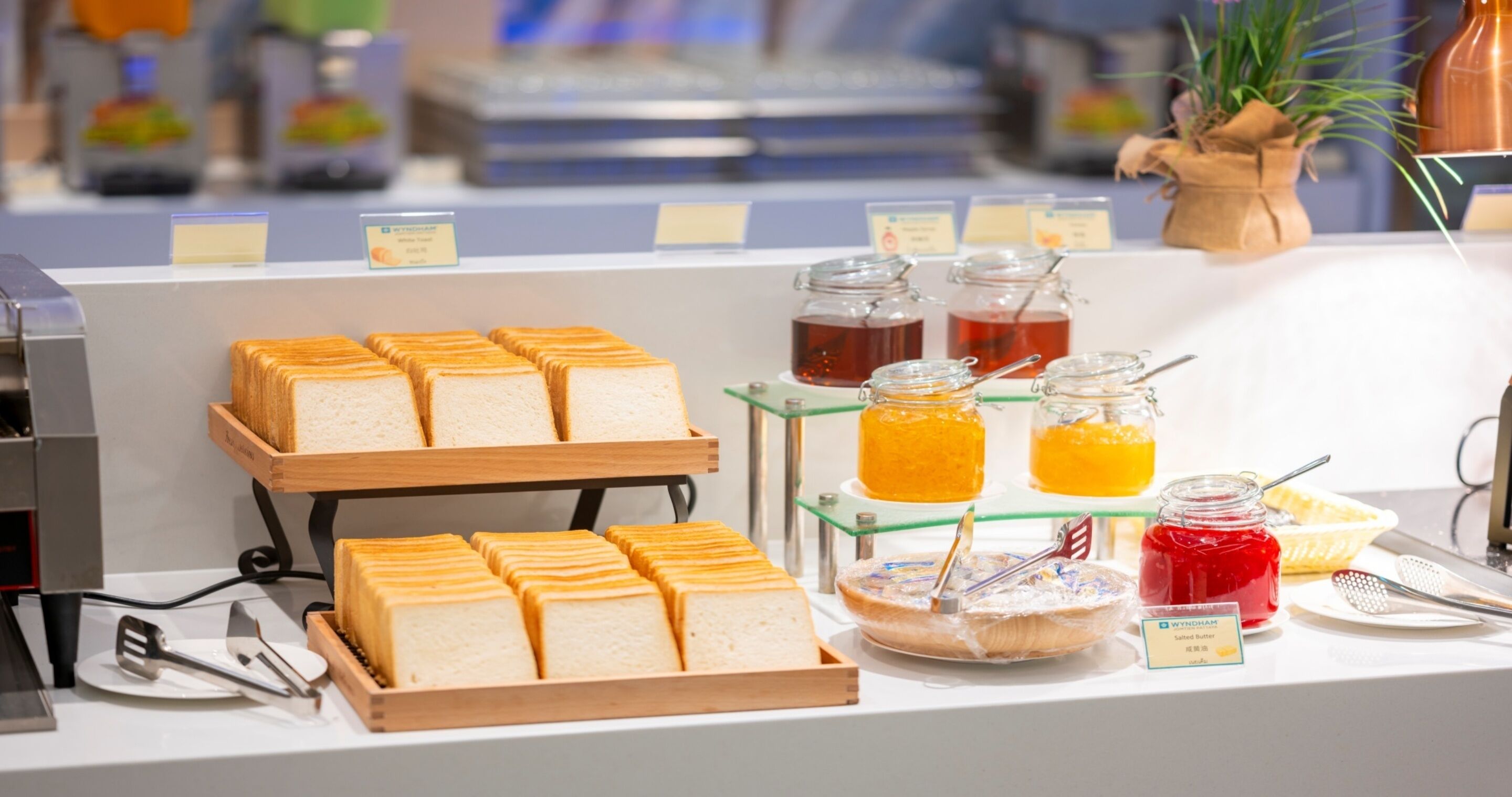 A breakfast buffet with bread, jams, and butter.