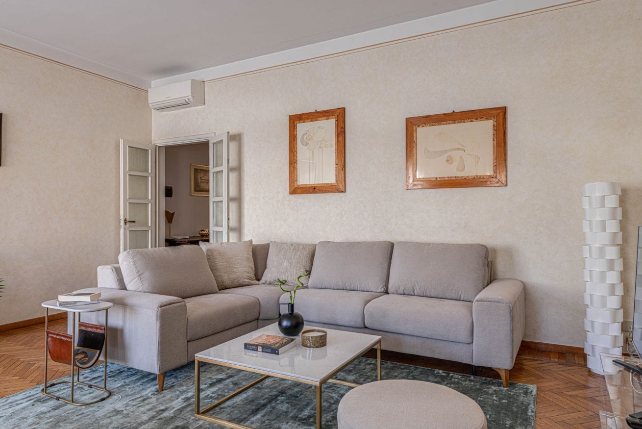 A living room with a sofa, coffee table, and a side table with a book.