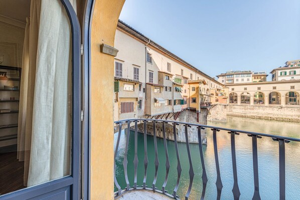 A balcony with a view of a river and buildings.